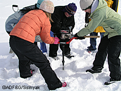 Lathrop High School students drill ice hole