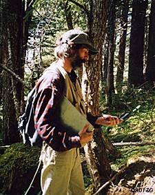 The author checks a compass bearing on a pellet survey Photo by Doug Larsen