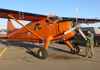 Wildlife biologist and pilot Tom Seaton prepares for a flight The radio antennea in the upper left mounted where the strut meets the wing enables biologists to track collared animals