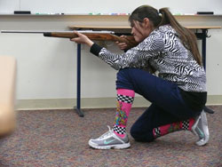 A student practices shooting positions