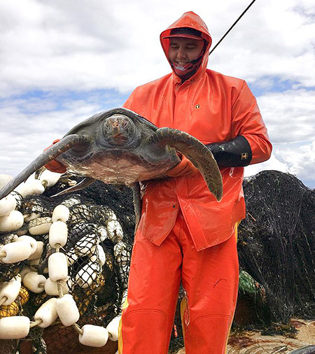 Jes Boyd with the green sea turtle before returning it to the water