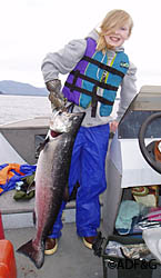 Eleven year old Emily Wood hoisting her recently landed king salmon while fishing with her father near Caamano Point near Ketchikan  Photo courtesy of Mike Wood