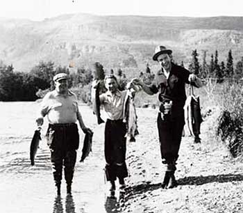 Three people on shoreline holding fish Cooper Landing Alaska 1940  Alaska State Library Doyle C Tripp photograph collection