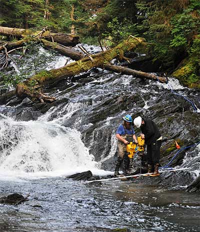 Kanalku Falls on Admiralty Island Rob Miller and Thor Eide drill holes in the 10x10 foot section of bedrock that was removed with explosives to deepen the jump pool below the falls picture courtesy of Randy Bates