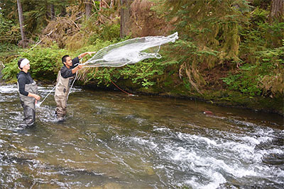 Kristen Kolden stands by while Ben Joseph makes a perfect castnet throw picture courtesy of Cathy AimoneMarten