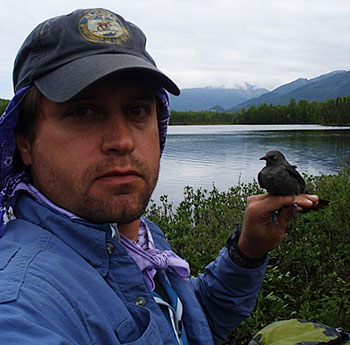 Biologist Dave Tessler with a rusty blackbird The World Conservation Union has put the rusty blackbird at high risk of extinction