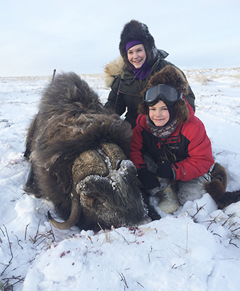 Hunting Nelson Island 13yearold Rylee Johnson purple balaclava and her 9yearold brother Ellis Johnson goggles with his Nelson Island bull muskox The siblings got their muskox on Valentine39s Day 2015 on a hunt with their dad Rafe