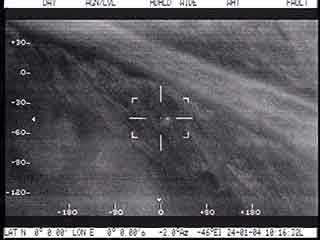 Airborne FLIR image of a polar bear den bright spot to the right of the bullseye along the Beaufort Sea coast Photo USFWSMarine Mammals Management