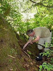 Dave Person ADFampG Biologist inserts the camera probe into the main entrance to the den