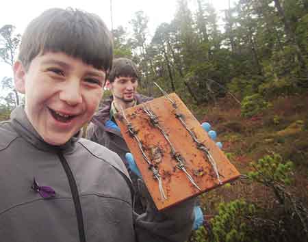 Taan Smith a student in Corby Wehmillerrsquos class smiles while holding up a hair board Courtesy of Corby Weyhmiller
