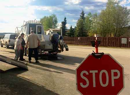 US Fish and Wildlife staff talking with boat owners at a roving watercraft inspection station at the Alcan border station