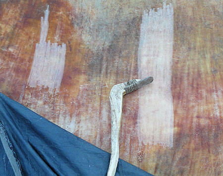 The authorrsquos flint bladed dryscraper The blade is hafted with deer rawhide cord to the split edge of a moose antler paddle In the photo the skin side of a bison hide is being worked with the stone dryscraper Photo by James Van Lanen
