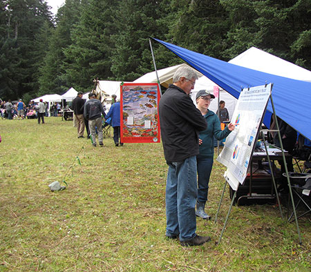 Division of Subsistence researcher Malla Kukkonen talks about the Divisionrsquos work with Lt Governor Byron Mallott in Yakutat at the communityrsquos annual Fairweather Day Festival Photo Barbara CellariusNPS