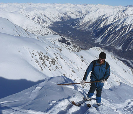 Ascending on traditional handmade skis Altai skier Mulchen nears the summit of a high peak in the Altai Mountains All photos by James Van Lanen