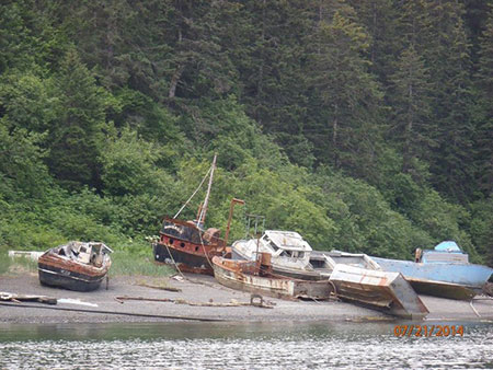 Abandoned vessels on a Port Graham beach Photo courtesy ADEC