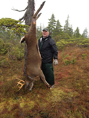 The author prepares to field dress a Sitka blacktailed deer Photo by Brian Castle