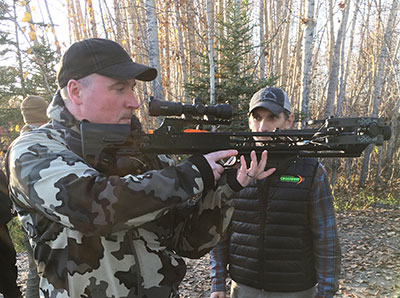 An archery instructor prepares to fire a crossbow at an instructor certification course in the fall of 2017