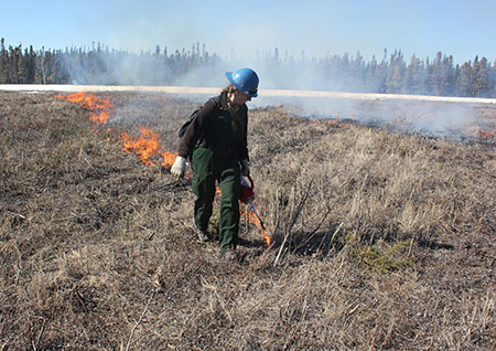 Sue Rodman putting fire on the ground on the Delta Range in 2018 Photo by Tim Mowry