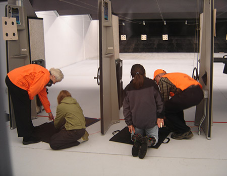 Hunter education volunteer instructors coach students at the Juneau indoor range Hunter education is provided to middle school students in Juneau through a cooperative program betweeen the schools and Fish and Game