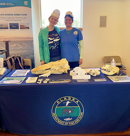 ADFampG Marine Mammal Program staff Kelsea Anthony left and Barb Lake right host an educational booth during the afternoon Belugas Count celebration at the Alaska Zoo