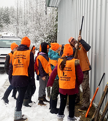 Jeff teaching a Hunter Ed class checking the chamber of a nonfunctional PVCtube quotfirearmquot