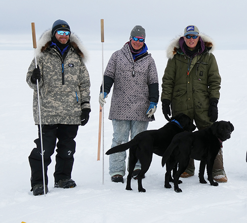 Ringed seal researchers L to R Justin Crawford Anna Bryan and Lori Quakenbush  Dogs L to R Stout and Indigo  Photo by Craig Perham