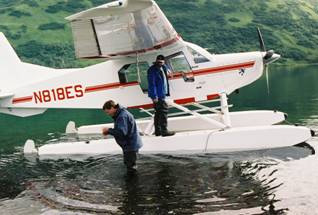 Collecting water samples near Thumb River Karluk Lake
