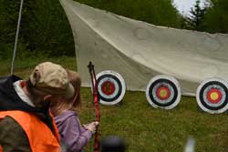 Young archer taking aim at a practice target